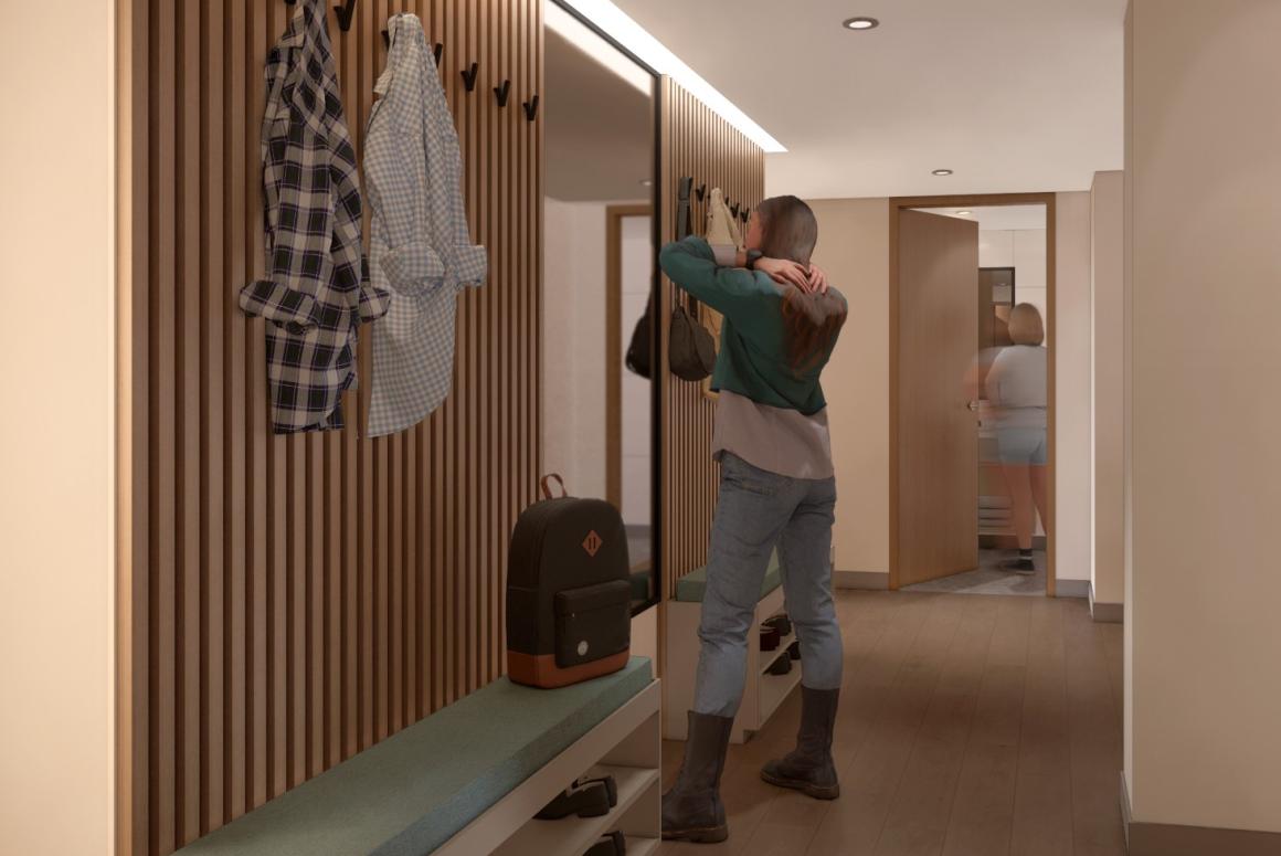 View of student in the entry way hanging their coat (rendering)