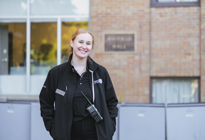 A Residence Life Coordinator out front of Bayfield Hall