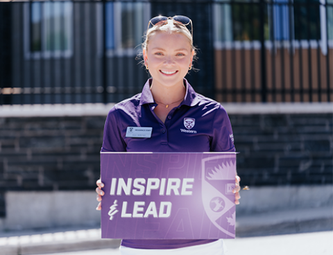 Residence staff member holding a sign